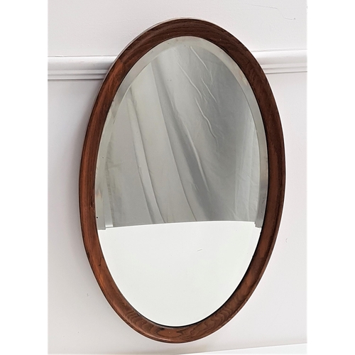 596 - OVAL WALL MIRROR
in an oak frame with a bevelled plate, 72cm high