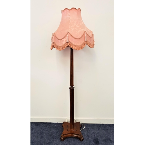 601 - 1930s WALNUT STANDARD LAMP
raised on a shaped base with four ribbed feet, with a shaped turned colum... 