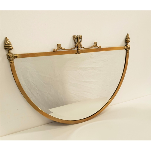 608 - SEMI ELLIPTICAL MIRROR
the brass frame with flaming torch finials flanking a stylised motif, with a ... 