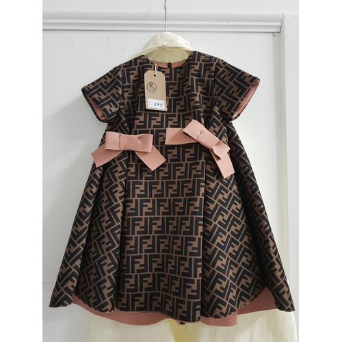 275 - NEW WITH TAGS FENDI KIDS FF LOGO DRESS
Size 4A, with pink bows, together with original Harrods recei... 