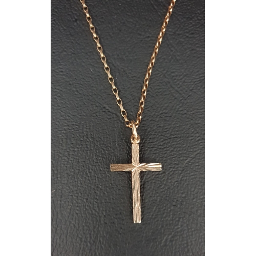 25 - UNMARKED GOLD CROSS PENDANT ON A NINE CARAT GOLD BELCHER LINK CHAIN 
with decorative engraving on th... 