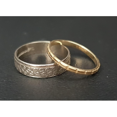 42 - TWO NINE CARAT GOLD RINGS 
comprising one thin yellow gold ring with raised double bar design and a ... 