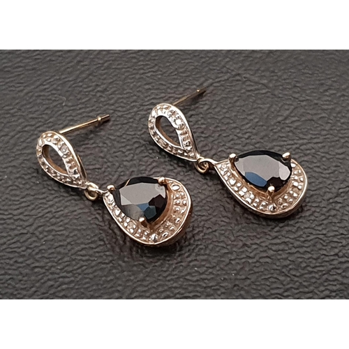 66 - NINE CARAT GOLD SAPPHIRE AND DIAMOND DROP EARRINGS 
the central pear cut sapphire on each approximat... 