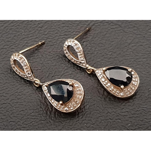 66 - NINE CARAT GOLD SAPPHIRE AND DIAMOND DROP EARRINGS 
the central pear cut sapphire on each approximat... 