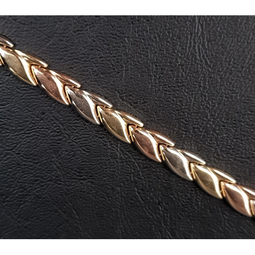 70 - THREE TONE EIGHTEEN CARAT GOLD BRACELET
made up of interchanging white, rose and yellow gold tulip m... 