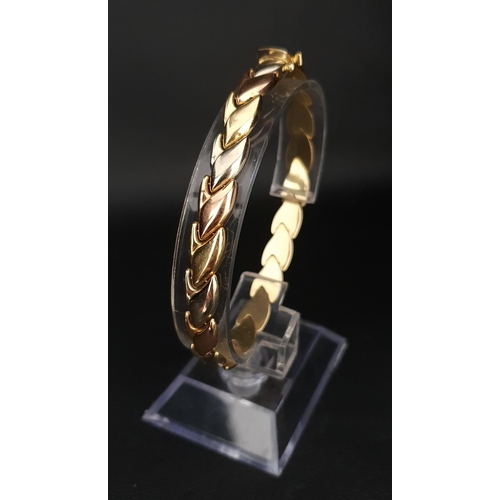 70 - THREE TONE EIGHTEEN CARAT GOLD BRACELET
made up of interchanging white, rose and yellow gold tulip m... 