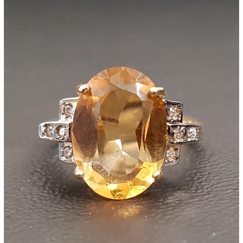 72 - CITRINE AND DIAMOND DRESS RING 
the oval cut citrine measuring approximately 13.9mm x 10mm x 5mm fla... 