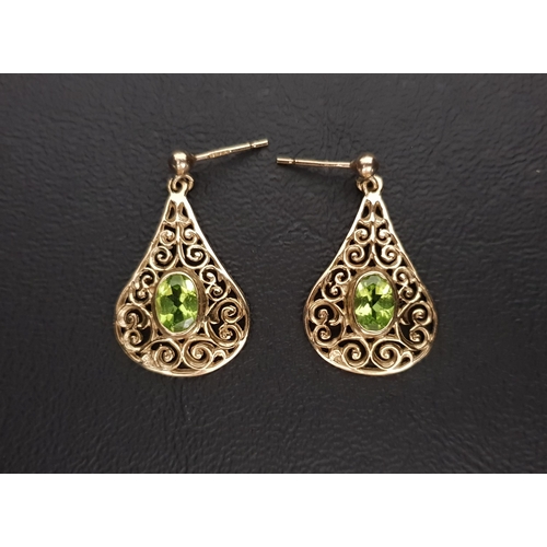 71 - PERIDOT SET DROP EARRINGS
the oval cut peridot on each approximately 0.65cts within a teardrop shape... 