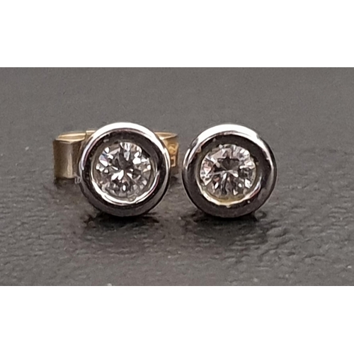 106 - PAIR OF BEZEL SET DIAMOND STUD EARRINGS
the diamonds totalling approximately 0.2cts, in nine carat g... 