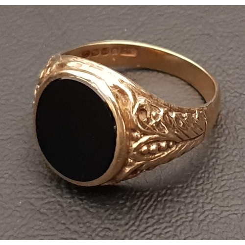 239 - NINE CARAT GOLD SIGNET RING 
the central oval black agate flanked by  decorative shoulders, approxim... 