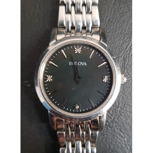 242 - LADIES BULOVA WRISTWATCH 
the black dial with baton five minuet markers and gemstones at three, six,... 