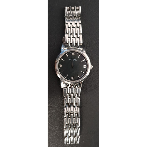 242 - LADIES BULOVA WRISTWATCH 
the black dial with baton five minuet markers and gemstones at three, six,... 