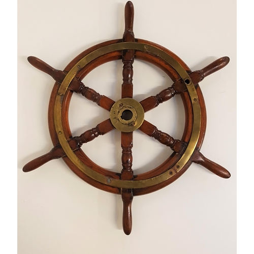 350 - VINTAGE TEAK SHIPS WHEEL
with a central brass sprocket marked C1060, with a brass reinforcing band t... 