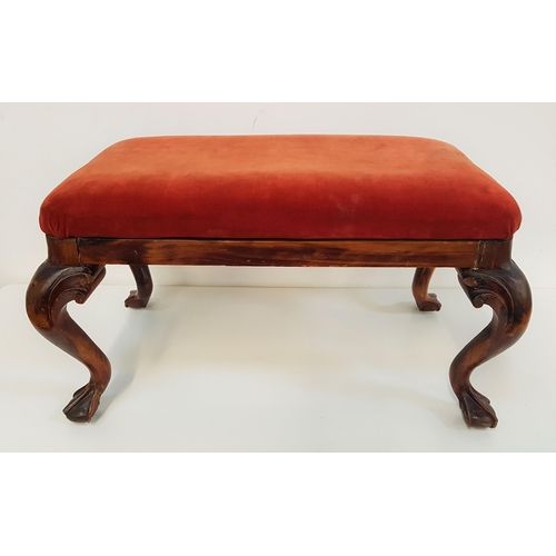 548 - VICTORIAN MAHOGANY FOOTSTOOL
with a rectangular padded top covered in red velvet, standing on cabrio... 