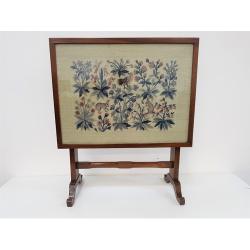 623 - COMBINATION MAHOGANY FIRE SCREEN
with an embroidered panel depicting wildlife and flowers, folding o... 