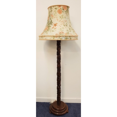 638 - CARVED TEAK STANDARD LAMP
raised on a circular stepped base with a carved square column decorated wi... 