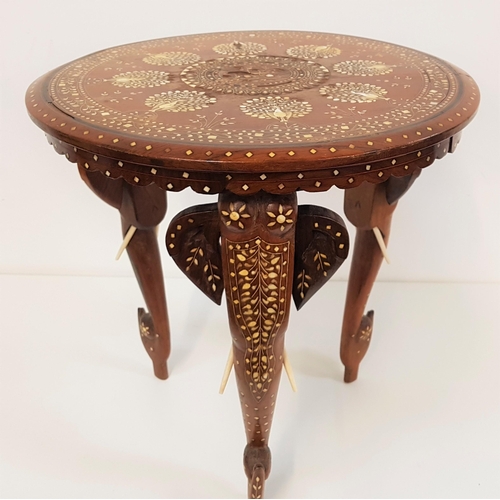 639 - INDIAN TEAK OCCASIONAL TABLE
the circular top inlaid with bone peacocks with a floral border, standi... 