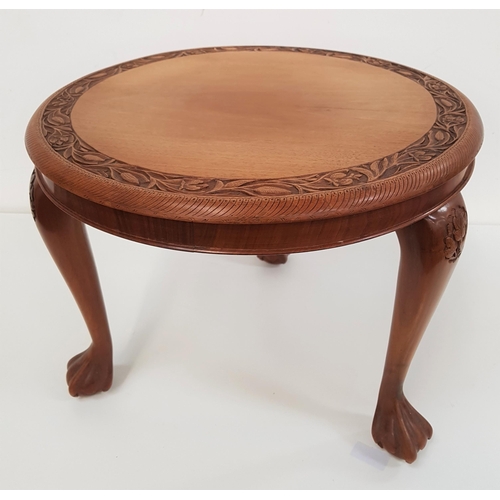 640 - TEAK OCCASIONAL TABLE
with a circular carved top standing on cabriole supports with claw and ball fe... 