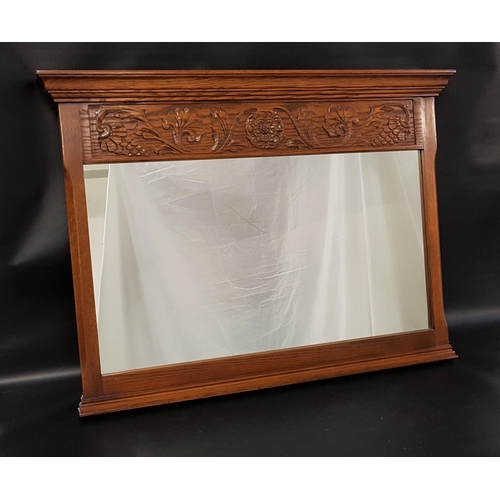 532 - JAYCEE OAK WALL MIRROR
with carved decoration above a rectangular plain plate, 59cm x 80.5cm