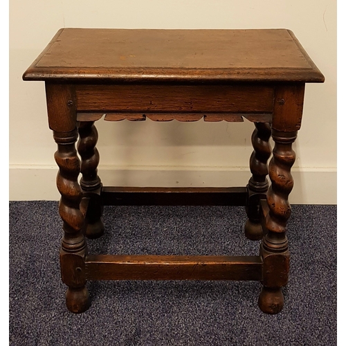 597 - 19th CENTURY OAK JOYNT STOOL
with a rectangular moulded top above a shaped frieze, standing on barle... 