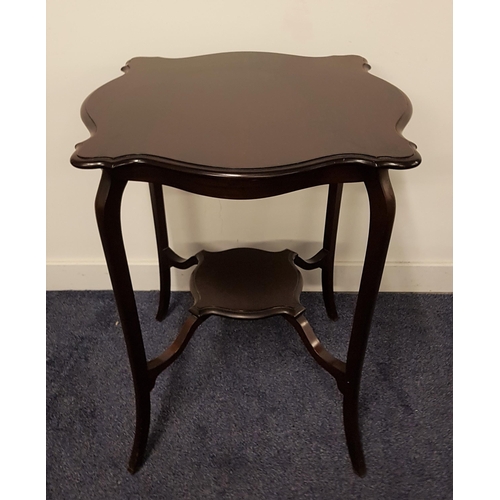 606 - EDWARDIAN MAHOGANY OCCASIONAL TABLE
with a shaped top standing on slender shaped supports united by ... 