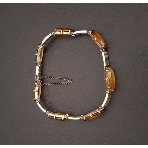 77 - CITRINE SET NINE CARAT WHITE GOLD BRACELET
the oval cut gemstones separated by pierced links, with s... 