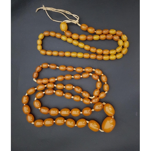 103 - TWO AMBER BEAD NECKLACES
the larger graduated example with beads ranging between 1cm and 2.4cm long,... 