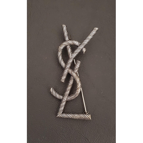 107 - YVES SAINT LAURENT BROOCH
formed by the letters YSL, 7cm high