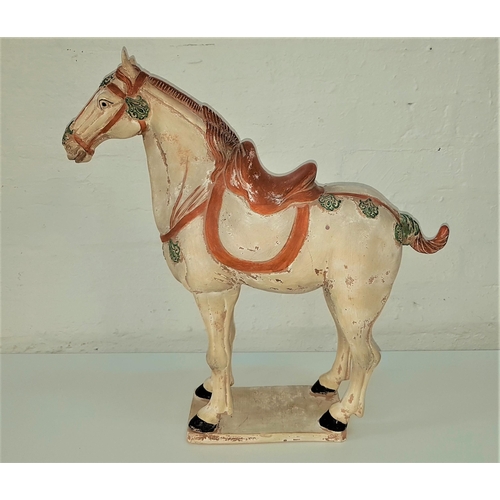 272 - POTTERY TANG STYLE HORSE
with a detailled head collar and saddle, on a rectangular plinth, 52.5cm hi... 