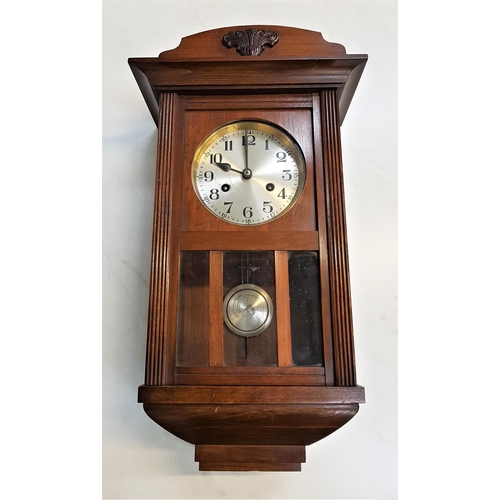 387 - OAK AND GLASS WALL CLOCK
with a silvered circular dial with Arabic numerals and an eight day movemen... 