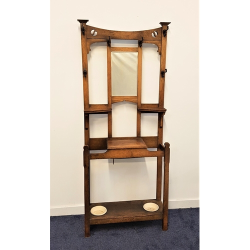 518 - ARTS & CRAFTS OAK HALL STAND
with a shaped and pierced carved top rail above a central rectangular b... 