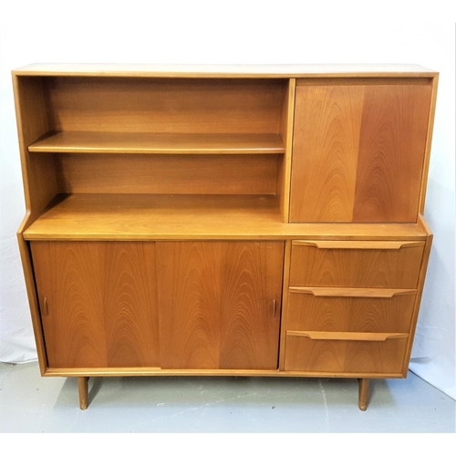 521 - HERBERT & GIBBS TEAK SIDE CABINET
with two open front shelves and a pull down flap revealing a glass... 