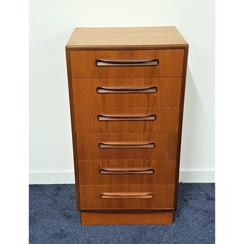 541 - G PLAN TEAK CHEST
of narrow proportions with six drawers with roll over handles, standing on a plint... 