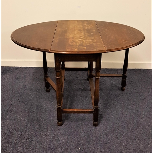 555 - OAK GATE LEG TABLE
with shaped drop flaps, standing on turned supports united by a stretcher, 92cm w... 