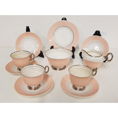 325 - SHELLEY TEA SERVICE
with a pale pink and white ground with silver highlights, comprising six cups an... 