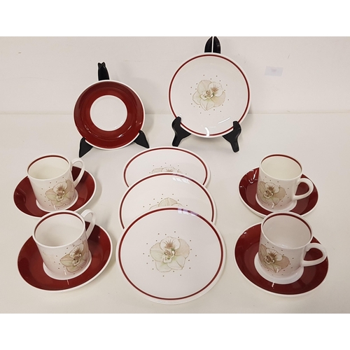 326 - SUSIE COOPER COFFEE SET
with a white and burgundy ground, the cups with floral decoration, comprisin... 