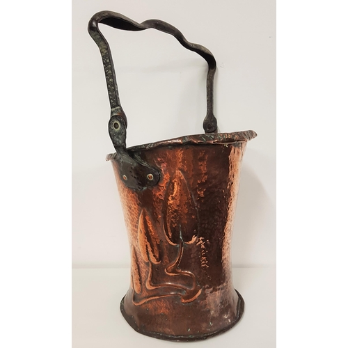 399 - ART NOUVEAU COPPER BUCKET
with a fold over iron handle, the body with hammered decoration and relief... 