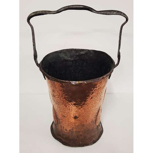 399 - ART NOUVEAU COPPER BUCKET
with a fold over iron handle, the body with hammered decoration and relief... 