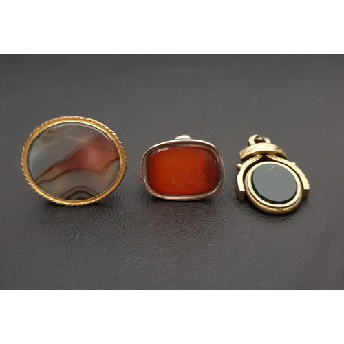24 - THREE VARIOUS FOBS
all in gold plated mounts, comprising a carnelian seal fob with engraved monogram... 