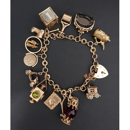 50 - GOOD NINE CARAT CHARM BRACELET
with heart padlock clasp and an interesting selection of gold charms,... 
