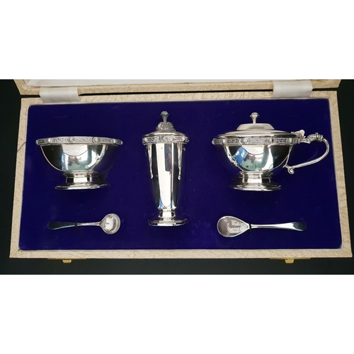 253 - ELIZABETH II CASED  SILVER CRUET SET
comprising a pepper pot, lidded mustard bowl with spoon and blu... 