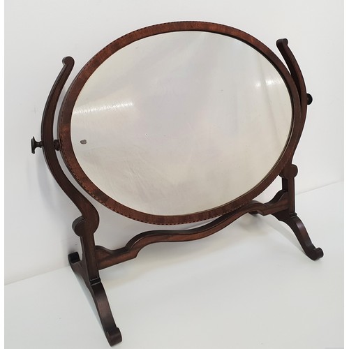 610 - MAHOGANY TOILET MIRROR
with an oval plate on shaped column supports, standing on splayed supports, 5... 