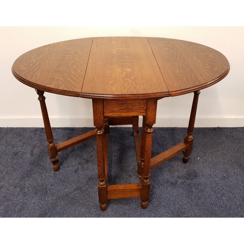 613 - OAK GATE LEG TABLE
with shaped drop flaps, standing on turned supports, 77cm wide