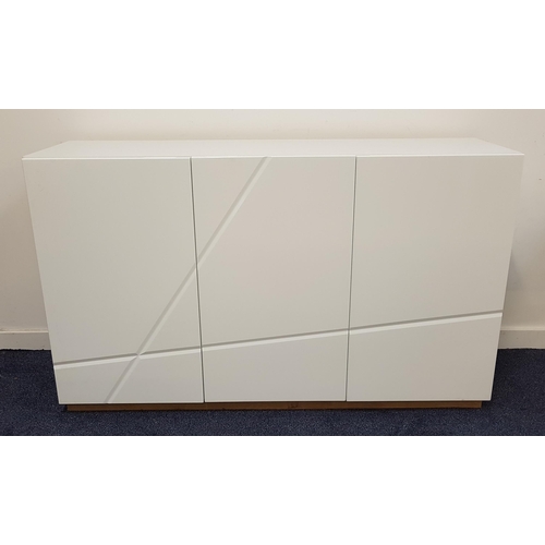 629 - MODERN SIDE CABINET
in gloss white with three cupboard doors with geometric slashed lines, opening t... 