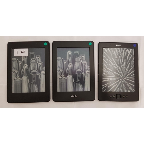 127 - THREE AMAZON KINDLE E-READERS
comprising Paperwhite 3 7th generation, serial number G090 G105 8302 0... 