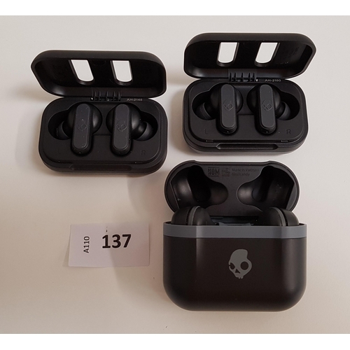 137 - THREE PAIRS OF SKULLCANDY EARBUDS
in charging cases