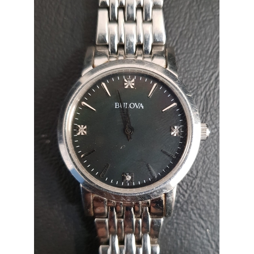 137 - LADIES BULOVA WRISTWATCH 
the black dial with baton five minute markers and gemstones at three, six,... 