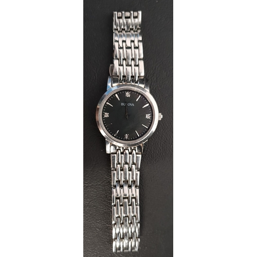 137 - LADIES BULOVA WRISTWATCH 
the black dial with baton five minute markers and gemstones at three, six,... 