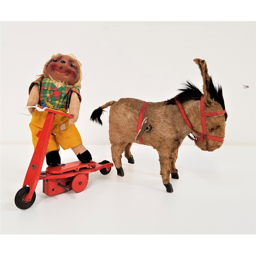 356 - VINTAGE CLOCKWORK DONKEY
with a fur covered body and a red bridle, 15.5cm high, together with a vint... 