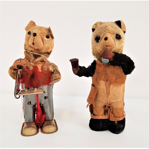 357 - JAPANESE TINPLATE CLOCKWORK BEAR
reading a book and wearing a pair of dungarees, 18cm high, together... 